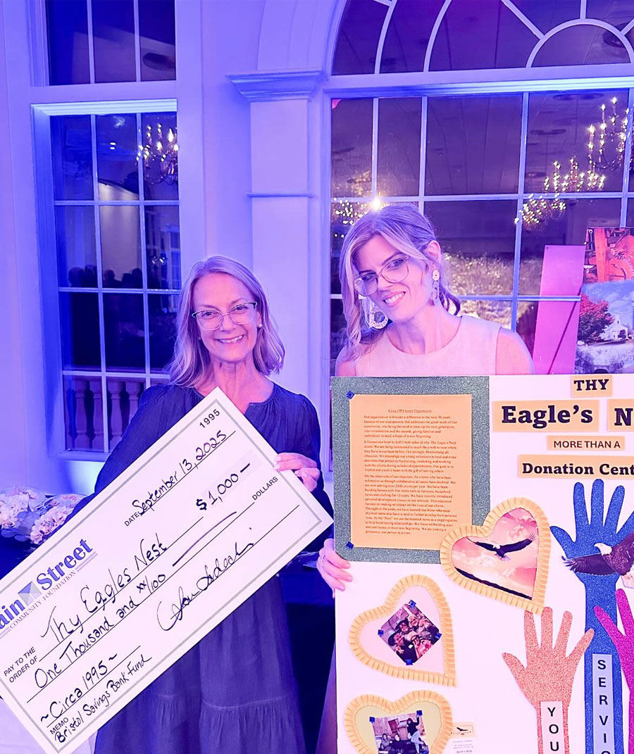 people holding check and sign